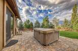Enjoy outdoor living at its finest with this spacious patio featuring a luxurious hot tub, perfect for relaxation and entertaining.
