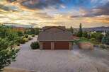 Discover this stunning property featuring a spacious paver driveway leading to a three-car garage, perfect for car enthusiasts or ample storage.
