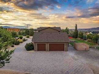 Discover this stunning property featuring a spacious paver driveway leading to a three-car garage, perfect for car enthusiasts or ample storage.