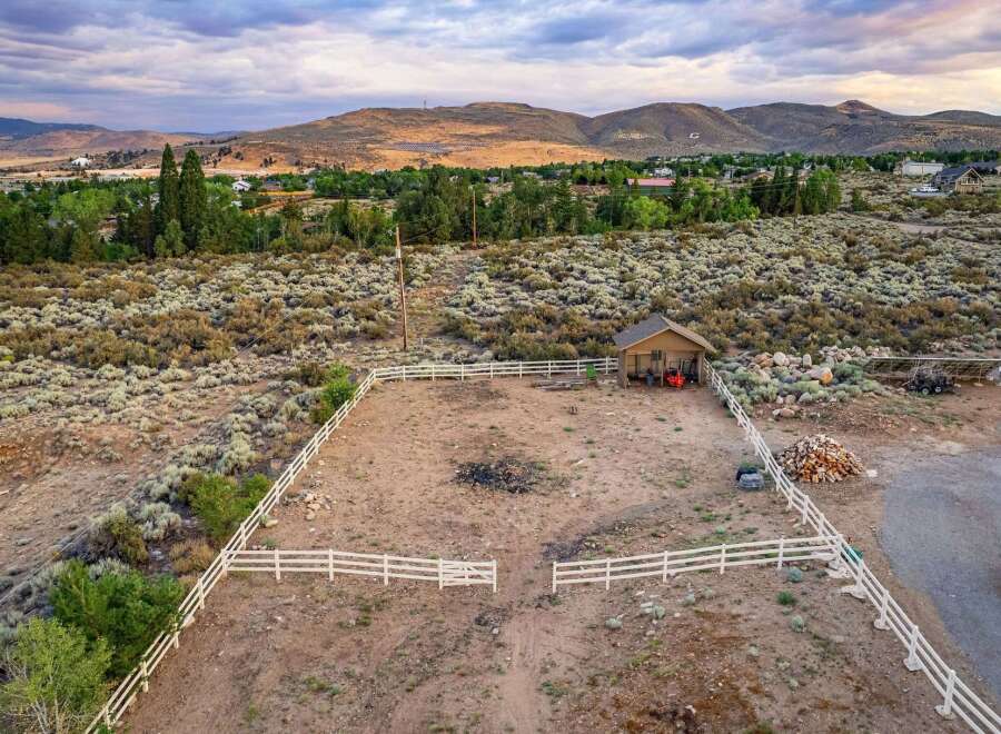 Discover this expansive property featuring a fenced corral, perfect for equestrian activities or livestock.