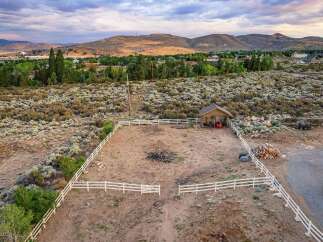 Discover this expansive property featuring a fenced corral, perfect for equestrian activities or livestock.