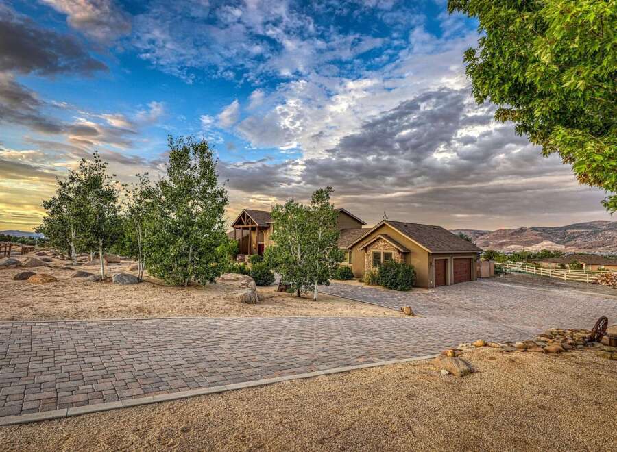 Discover this stunning property featuring a beautifully crafted home with a welcoming porch and a detached garage with two bays.