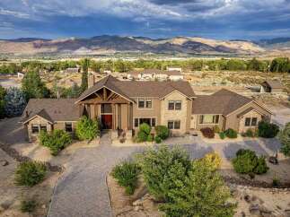 Discover this stunning custom-built estate offering breathtaking mountain views and unparalleled privacy.