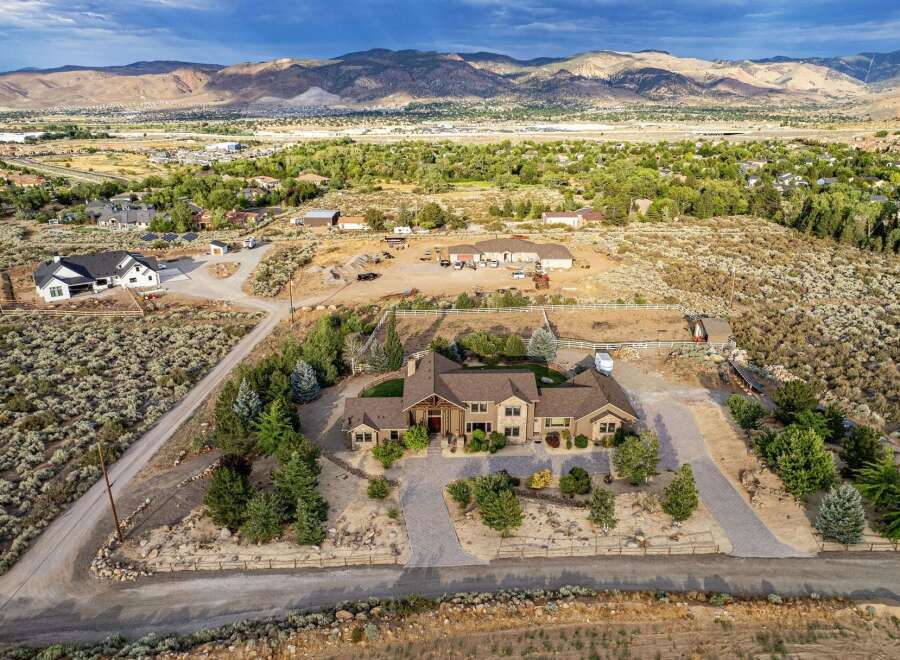 Discover this stunning custom-built estate nestled on a sprawling lot with breathtaking mountain views.
