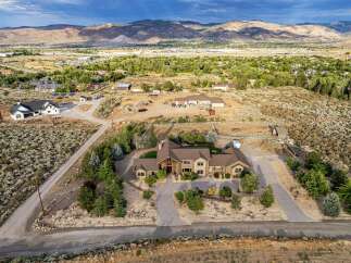 Discover this stunning custom-built estate nestled on a sprawling lot with breathtaking mountain views.
