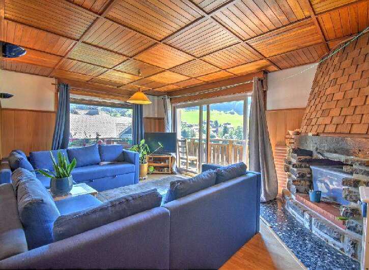 Experience cozy living in this charming living room featuring a spacious blue sectional sofa perfect for relaxation.