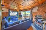 Experience cozy living in this charming living room featuring a spacious blue sectional sofa perfect for relaxation.