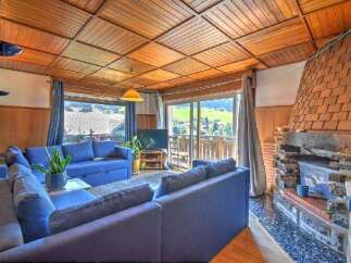 Experience cozy living in this charming living room featuring a spacious blue sectional sofa perfect for relaxation.