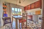 Enjoy breathtaking mountain views from this charming kitchen and dining area, featuring a spacious table perfect for family meals.