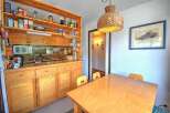 This charming kitchen features warm wooden cabinetry and open shelving, providing ample storage and display space.