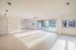 Experience modern living in this spacious, light-filled apartment featuring sleek tile flooring and recessed lighting throughout.