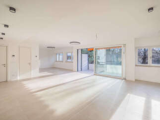 Experience modern living in this spacious, light-filled apartment featuring sleek tile flooring and recessed lighting throughout.