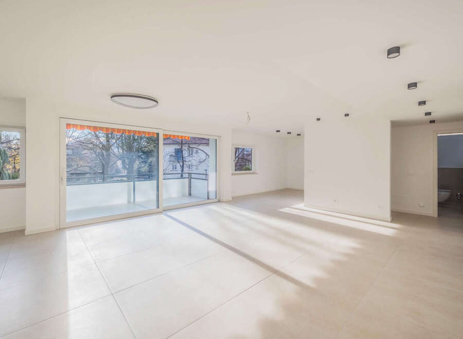 Experience modern living in this bright and airy apartment, featuring expansive floor-to-ceiling windows that flood the space with natural light.