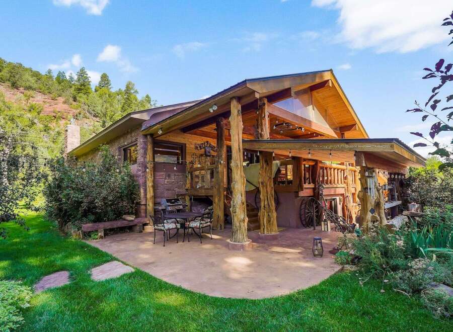 Experience rustic charm and mountain living in this unique log-accented home, nestled against a scenic hillside.