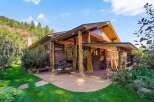 Experience rustic charm and mountain living in this unique log-accented home, nestled against a scenic hillside.