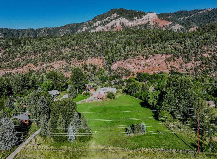 Nestled against a backdrop of majestic red rock mountains and lush green forests, this property offers a serene and private retreat.