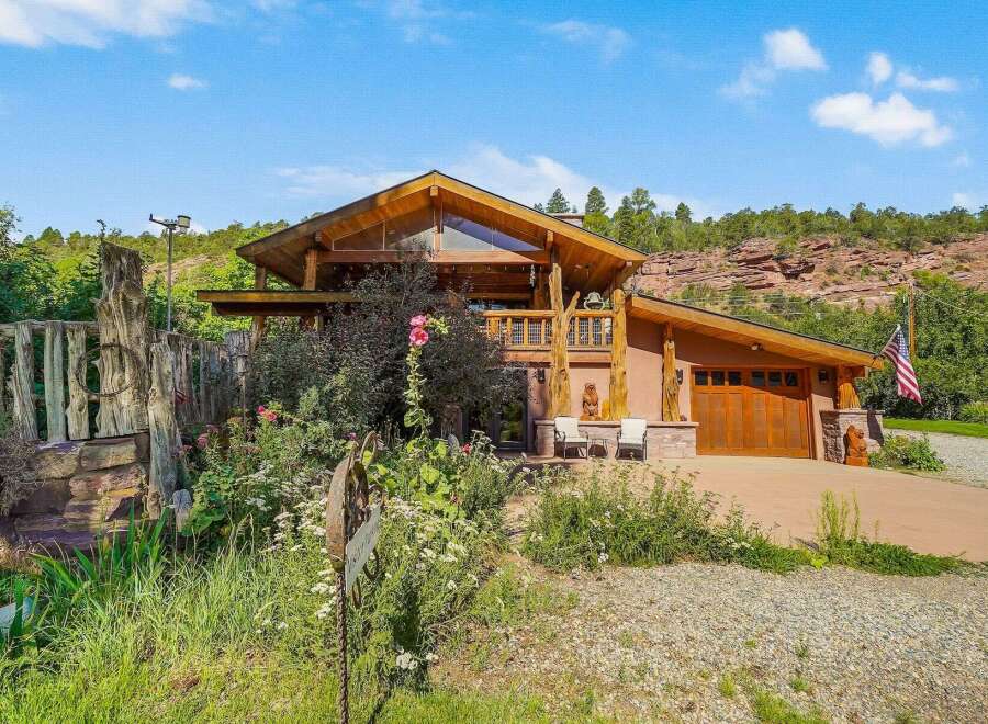 Experience rustic charm and breathtaking mountain views from this unique log and stucco home.