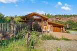 Experience rustic charm and breathtaking mountain views from this unique log and stucco home.