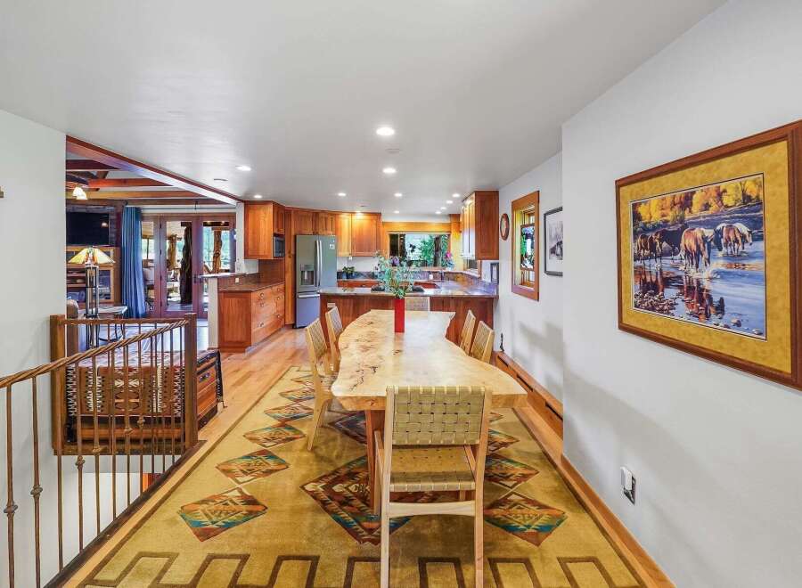 Experience rustic charm in this spacious dining area, featuring a live-edge wood table perfect for gatherings.