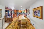 Experience rustic charm in this spacious dining area, featuring a live-edge wood table perfect for gatherings.