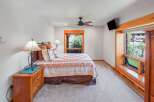 This charming bedroom features a cozy queen-size bed adorned with a Southwestern-inspired quilt and decorative pillows.