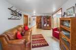 Step into a rustic-inspired living space featuring a plush leather sofa complemented by a vibrant Southwestern rug.