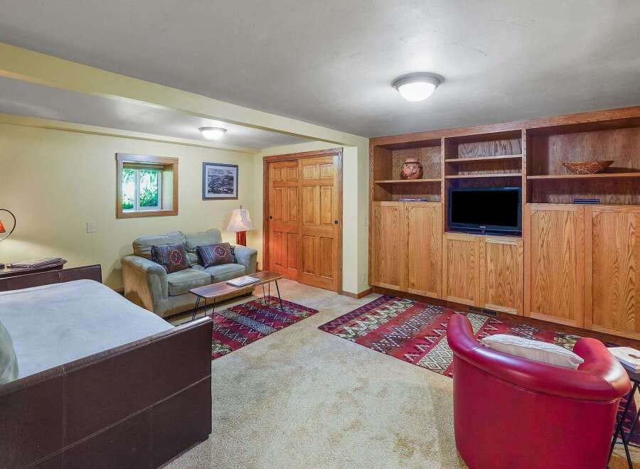 This cozy living area features a comfortable sofa and a daybed, perfect for relaxing or hosting guests.