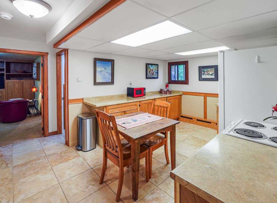 Discover this charming kitchen featuring a cozy dining area with a wooden table and chairs, perfect for intimate meals.