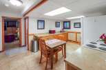 Discover this charming kitchen featuring a cozy dining area with a wooden table and chairs, perfect for intimate meals.