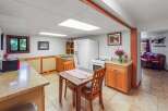 Discover this charming basement apartment featuring a compact kitchen with ample cabinet space and a dining area perfect for intimate meals.
