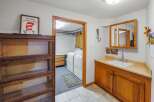 Discover a functional laundry room and a convenient vanity area, perfect for everyday living.