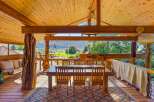 Experience rustic charm and breathtaking views from this covered outdoor dining area.