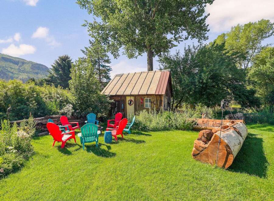 Escape to this charming rustic cabin nestled amongst lush greenery, perfect for a serene getaway.