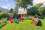 Escape to this charming rustic cabin nestled amongst lush greenery, perfect for a serene getaway.