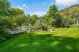 Escape to this serene backyard oasis, complete with a relaxing hammock perfect for unwinding.