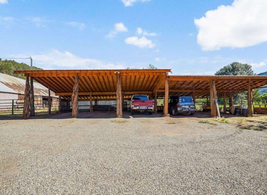 Discover this expansive covered parking area, perfect for protecting your vehicles and equipment from the elements.
