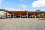 Discover this expansive covered parking area, perfect for protecting your vehicles and equipment from the elements.