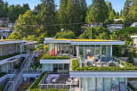 Experience modern luxury in this stunning multi-level residence featuring expansive balconies and lush green roofs.