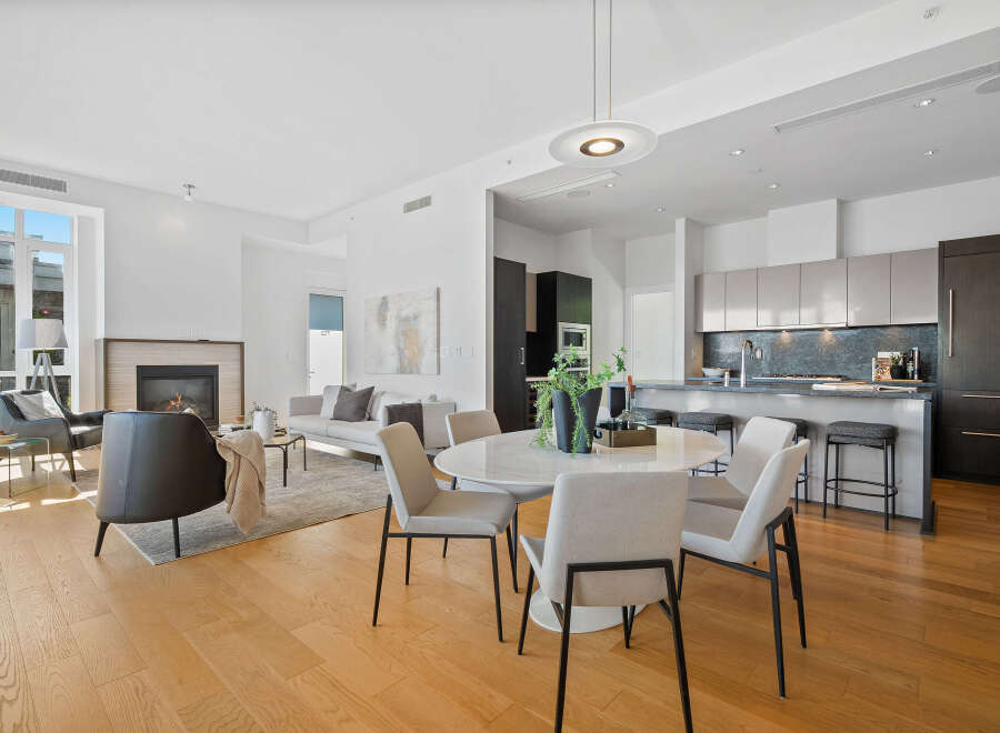 Experience modern living in this open-concept space featuring a sleek kitchen with ample cabinetry and a stylish island, perfect for entertaining.