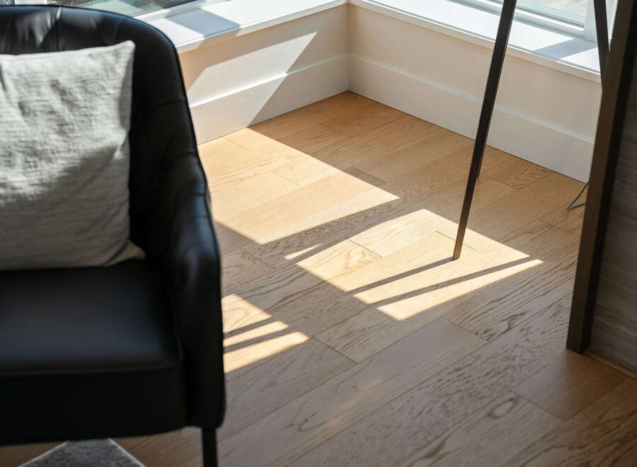 Experience natural light flooding into this elegant living space, highlighting the beautiful hardwood floors.