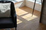Experience natural light flooding into this elegant living space, highlighting the beautiful hardwood floors.