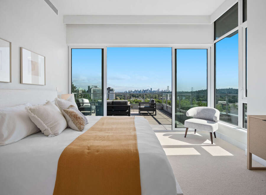 Experience luxurious urban living with this stunning bedroom featuring a king-sized bed and breathtaking panoramic city and bridge views.