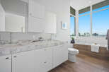 Experience modern luxury in this stunning bathroom featuring a sleek double vanity with marble countertops and contemporary fixtures.