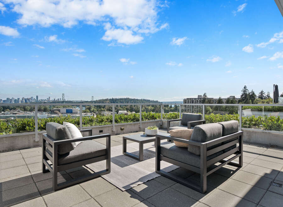 Enjoy breathtaking panoramic views from this stunning rooftop patio, perfect for entertaining or relaxing.