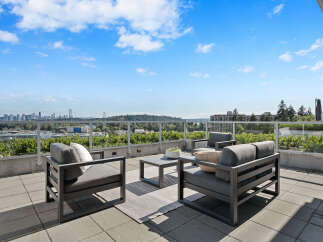 Enjoy breathtaking panoramic views from this stunning rooftop patio, perfect for entertaining or relaxing.
