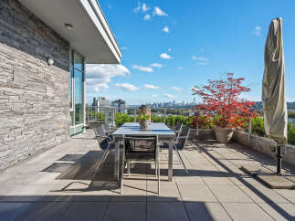 Enjoy breathtaking city and water views from this expansive private terrace, perfect for al fresco dining and entertaining.
