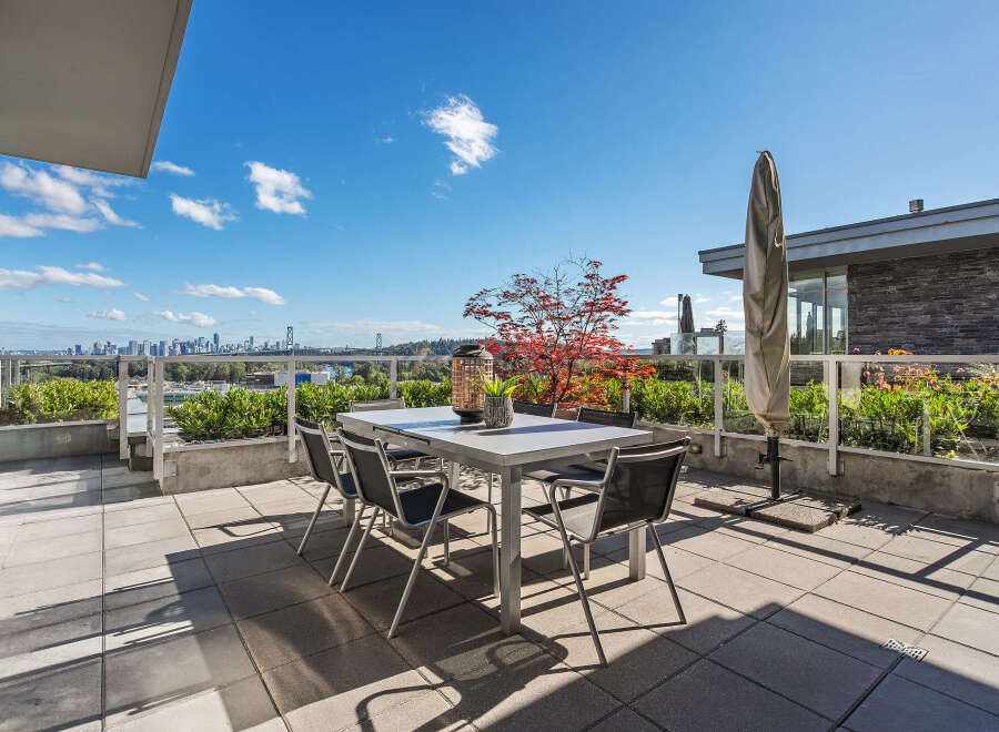 Enjoy breathtaking city and water views from this expansive rooftop patio, perfect for al fresco dining and entertaining.