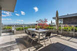Enjoy breathtaking city and water views from this expansive rooftop patio, perfect for al fresco dining and entertaining.
