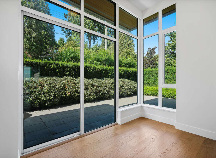 Experience seamless indoor-outdoor living with expansive floor-to-ceiling windows that flood this space with natural light.