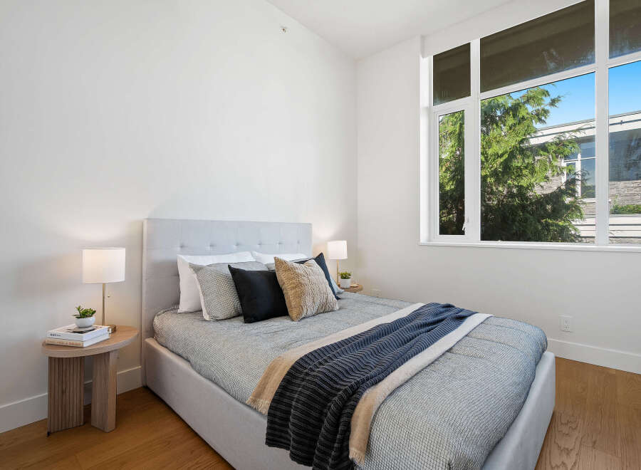 Experience modern comfort in this beautifully appointed bedroom, featuring a plush bed with a stylish upholstered headboard.